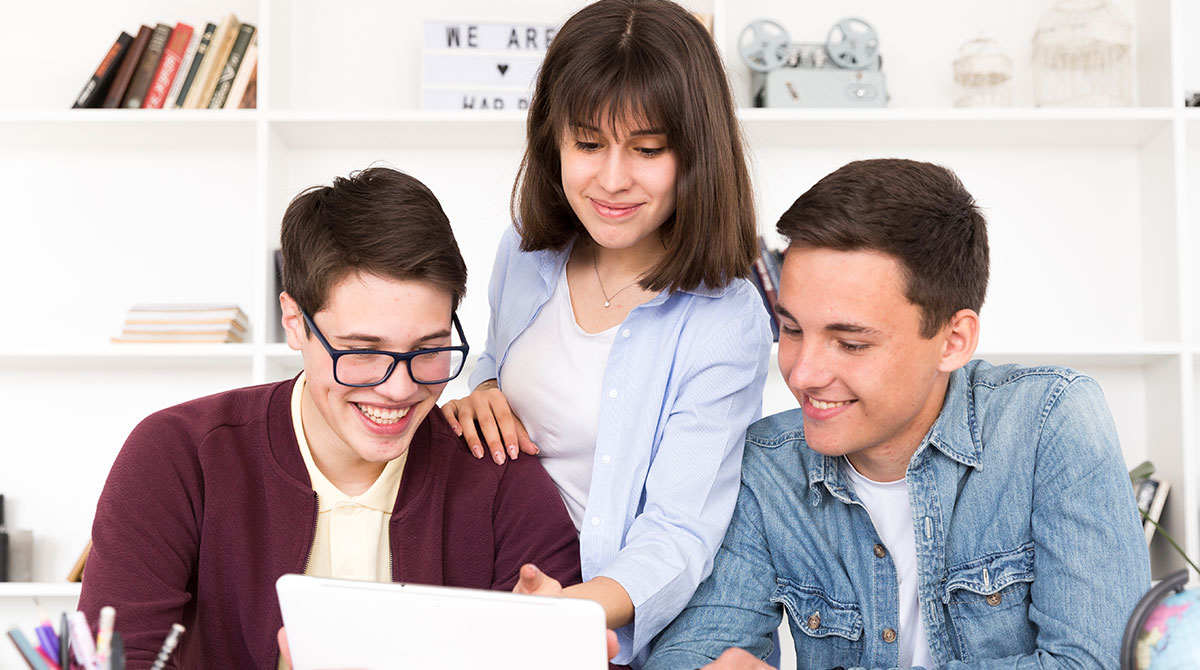 Office girl teaching accounting work to her two colleagues