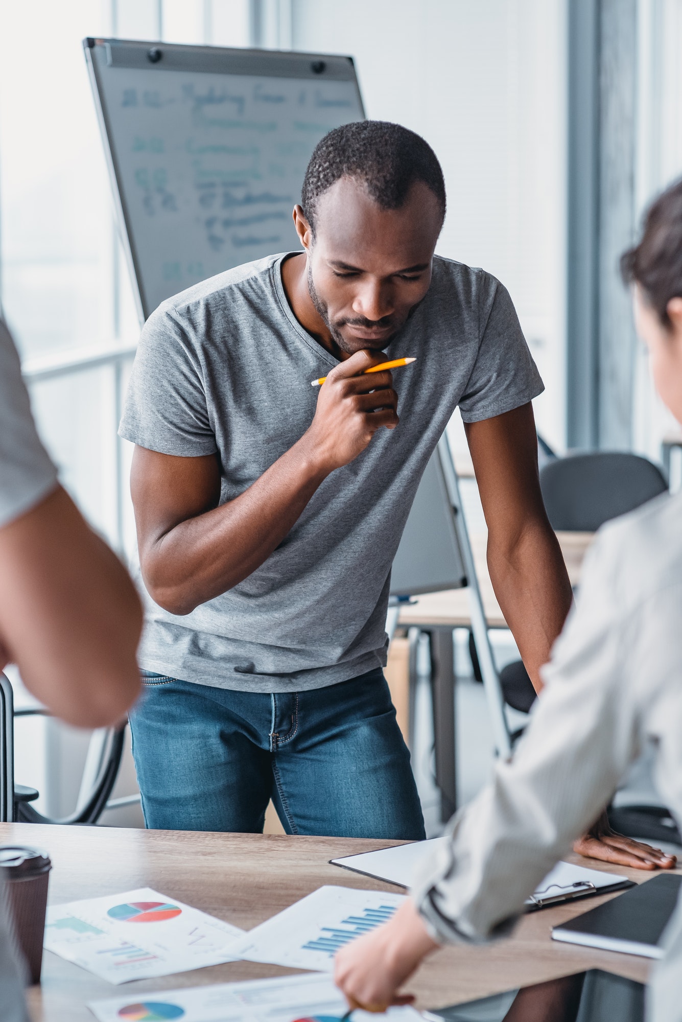 Man holding a pencil, thinking about how to solve accounting problems