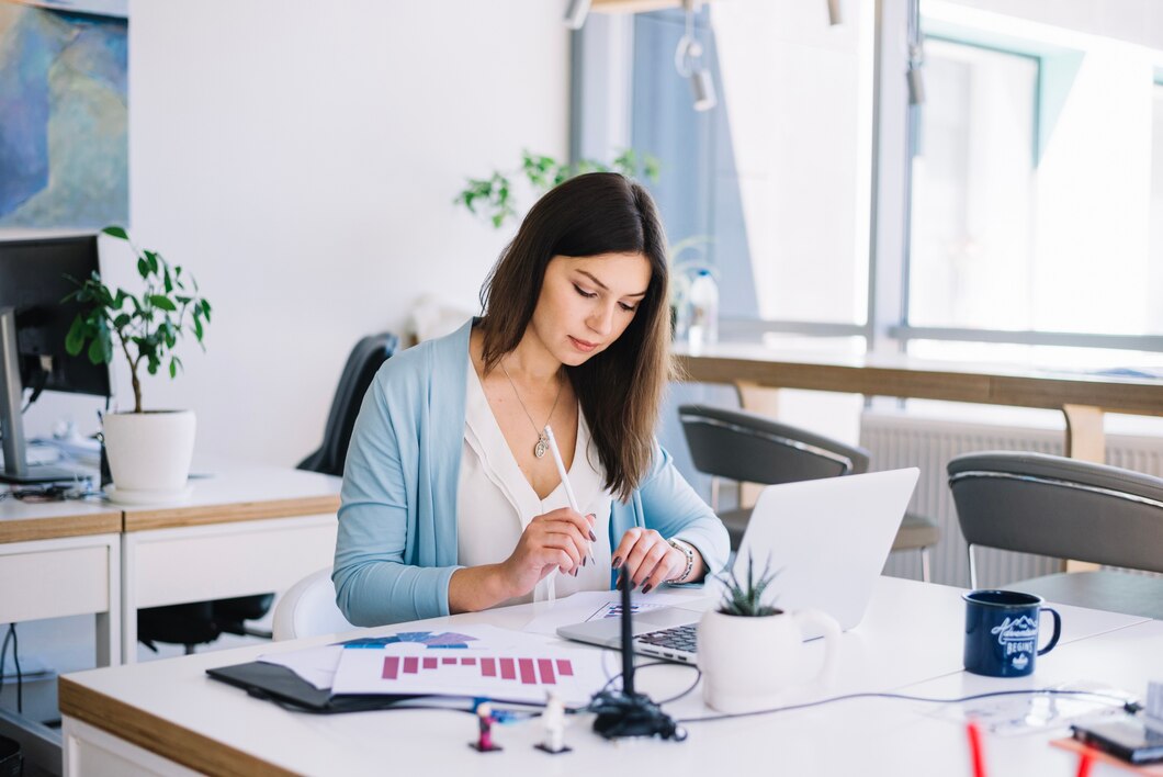 Office girl using laptop at her desk in the tax accounting firm