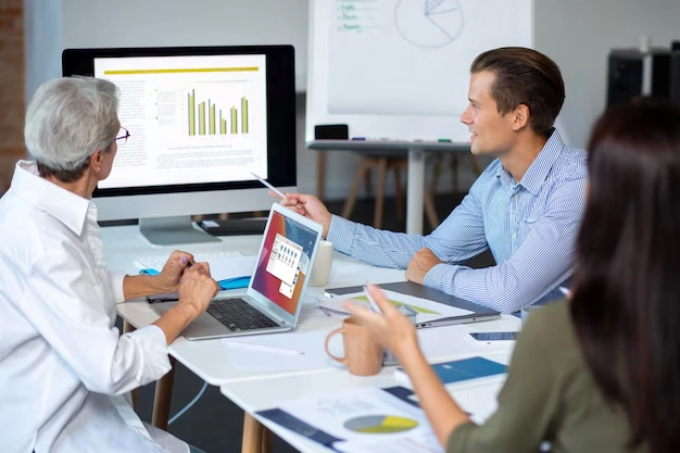 Angel investors analyzing financial services data on computer screens during investment strategy meeting
