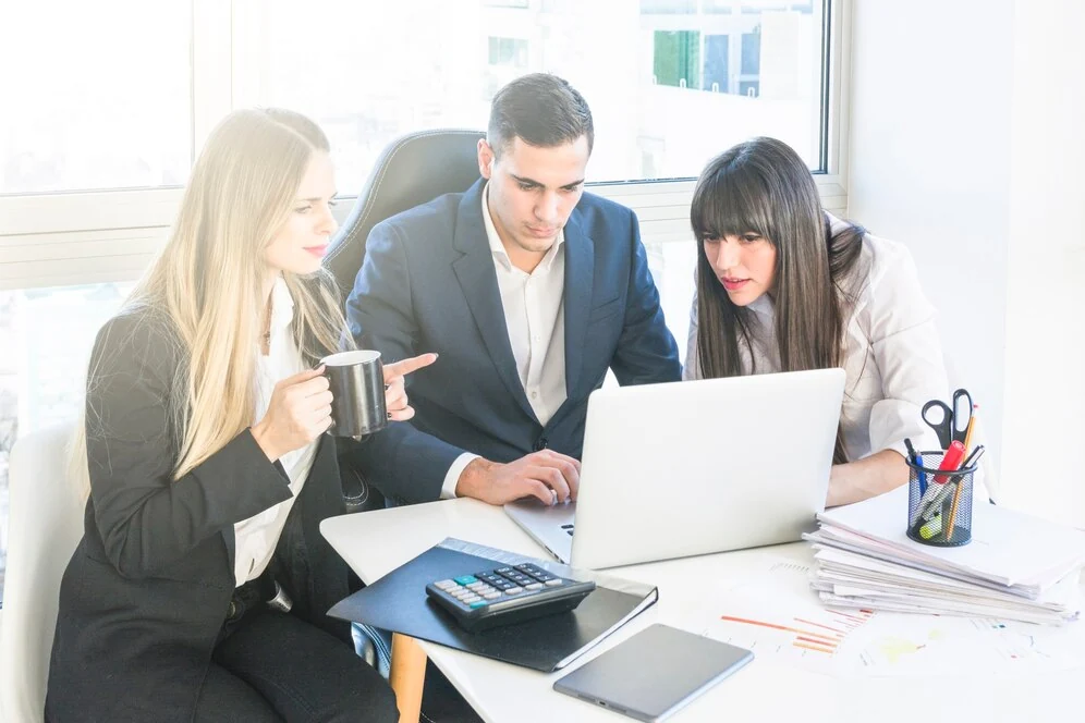 business team discussing efficient bookkeeping services and financial records with laptop and documents