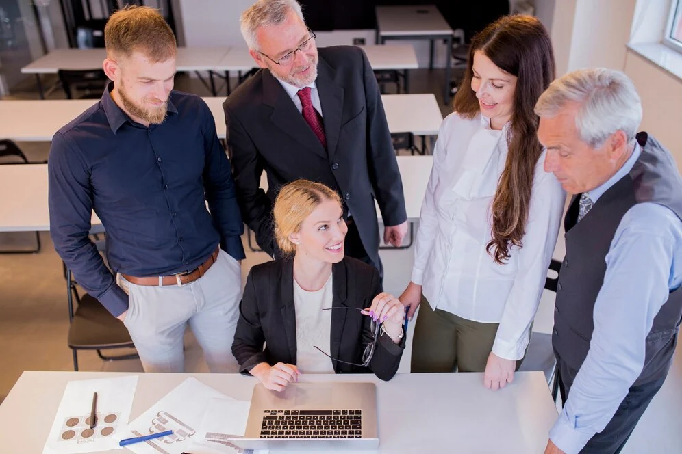business team discussing bookkeeping solutions and financial records in office with laptop