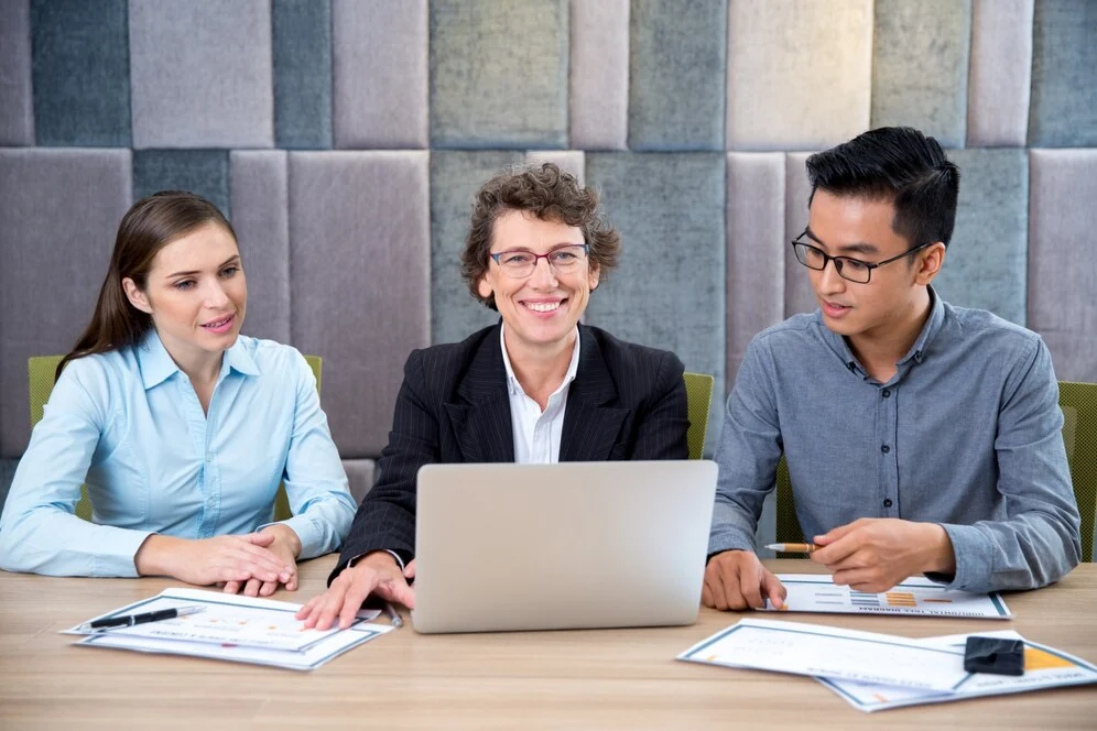 business team reviewing payroll and VAT return services with laptop and documents
