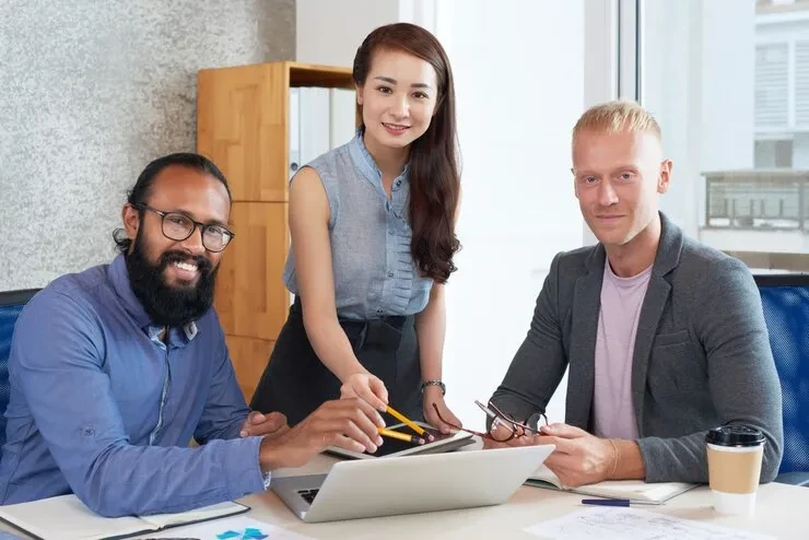 Professional team discussing intellectual property royalty management services in modern office