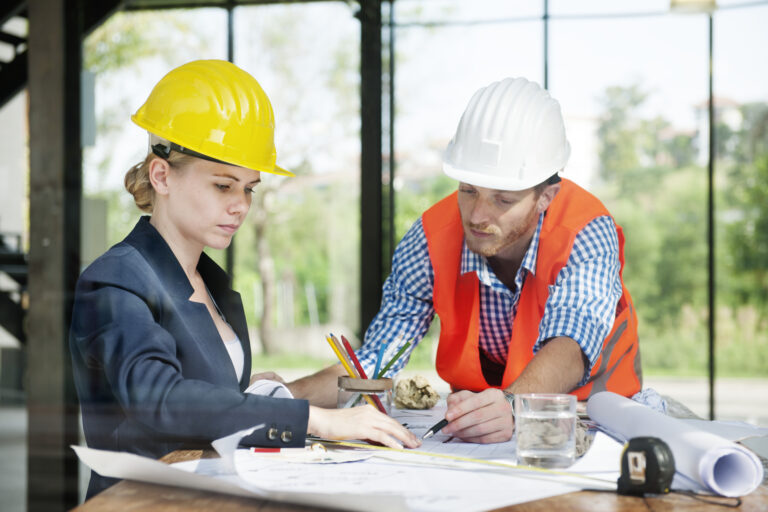Architect and engineer discussing a construction project