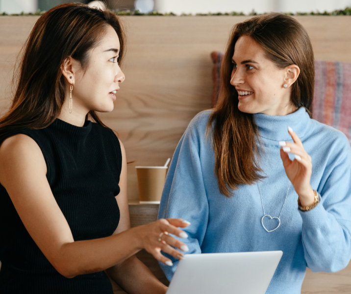 Two office girls, accountant and bookkeeper, watching each other happily