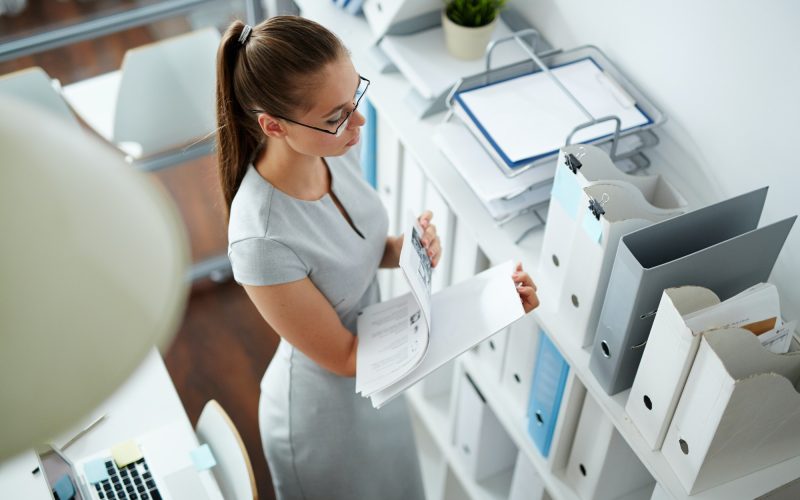 Office girl checking bookkeeping and accounting papers in the office for forex traders