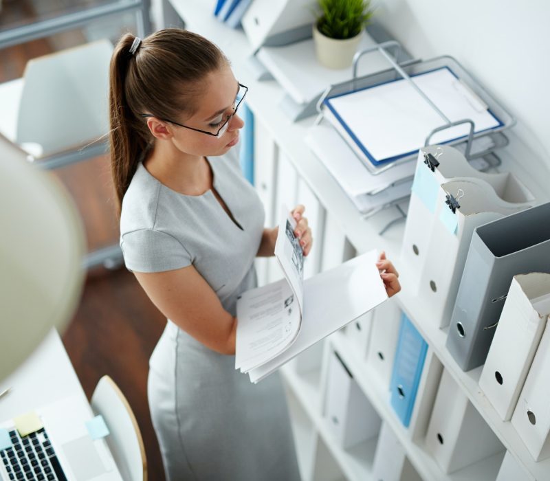 Accountant at work Office girl checking bookkeeping and accounting papers in the office for forex traders
