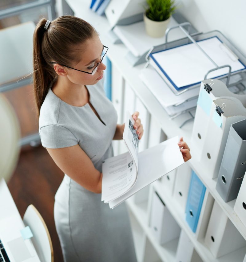 Accountant at work Office girl checking bookkeeping and accounting papers in the office for forex traders