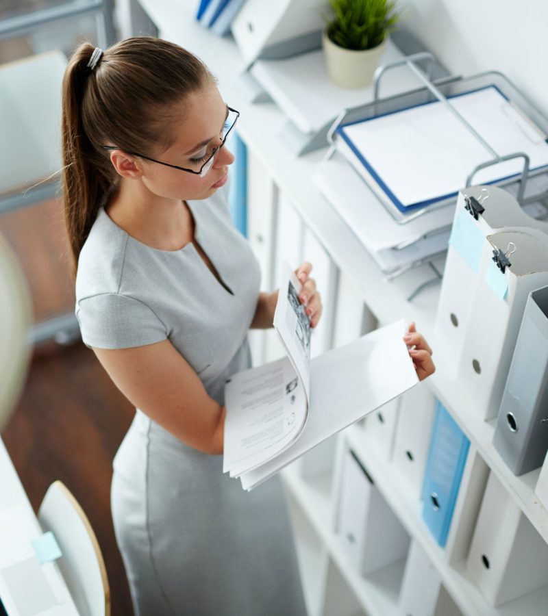 Accountant at work Office girl checking bookkeeping and accounting papers in the office for forex traders