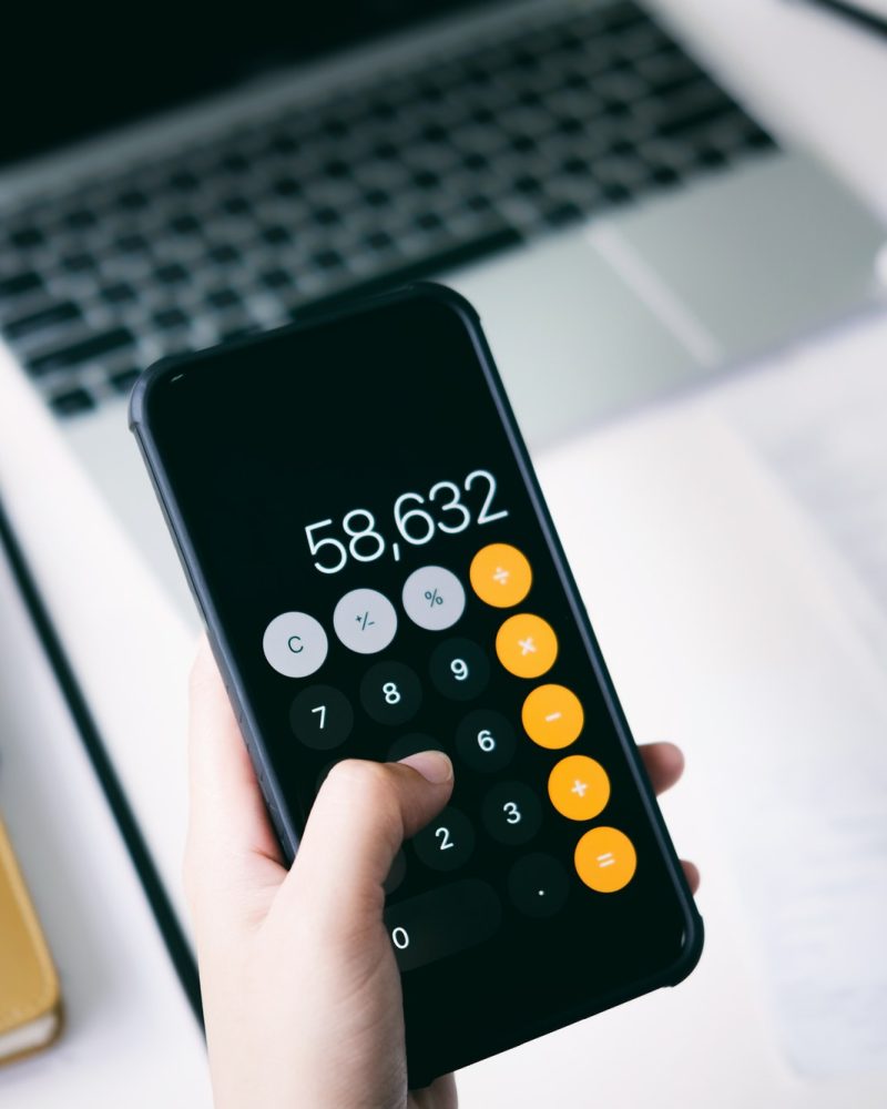 Accountant using mobile phone calculate the budget, Payroll Services, Accountants for Uber drivers