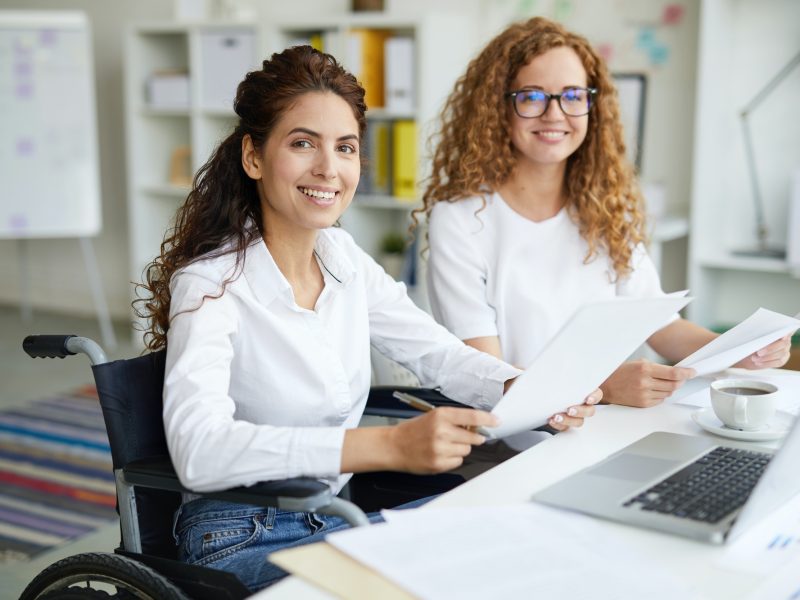 Pearl Lemon Accountants Girls Two office girls in white dresses smiling with a laptop on the table