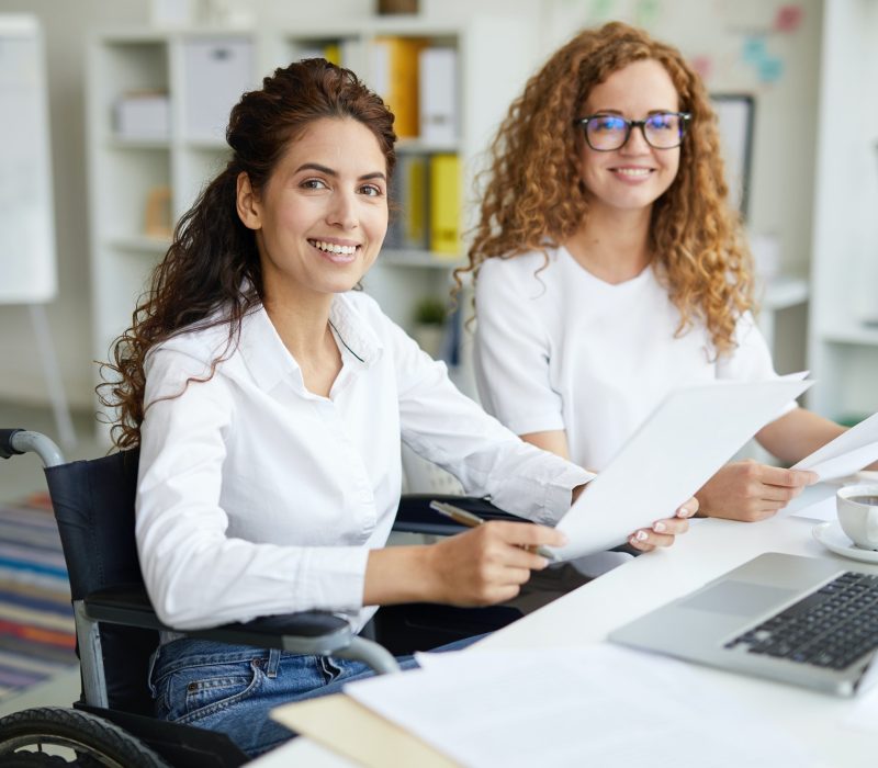 Pearl Lemon Accountants Girls Two office girls in white dresses smiling with a laptop on the table