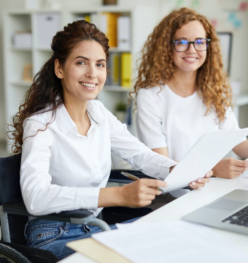 Pearl Lemon Accountants Girls Two office girls in white dresses smiling with a laptop on the table