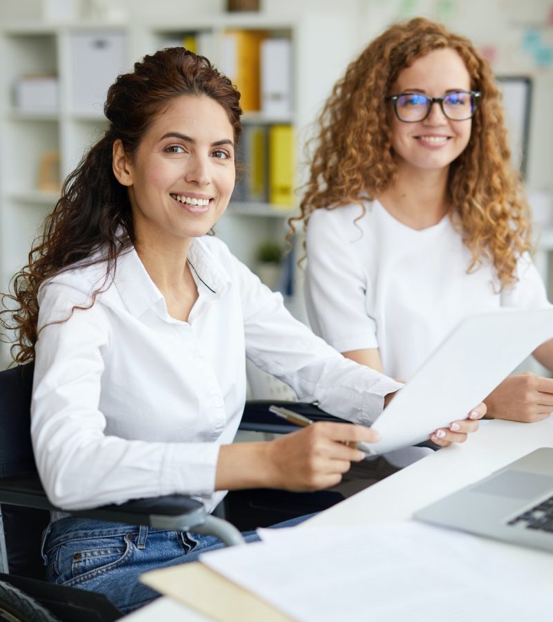 Pearl Lemon Accountants Girls Two office girls in white dresses smiling with a laptop on the table