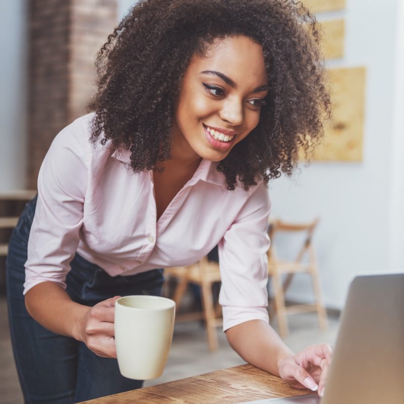 Pearl Lemon Accountants Office girl holding a cup in her hand while doing bookkeeping