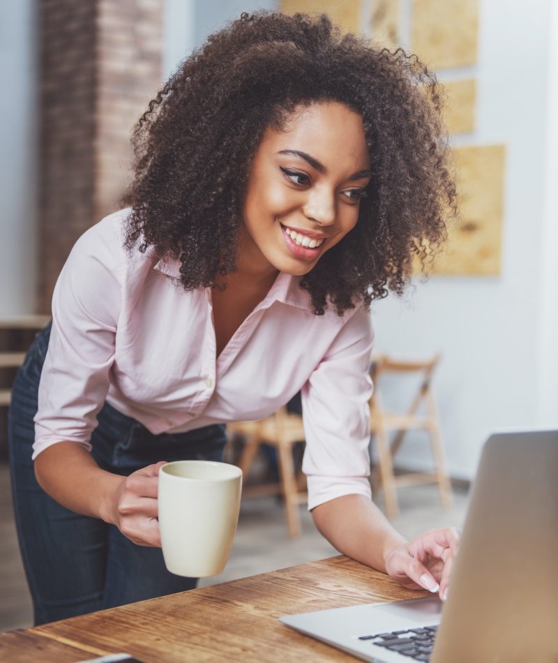 Pearl Lemon Accountants Office girl holding a cup in her hand while doing bookkeeping