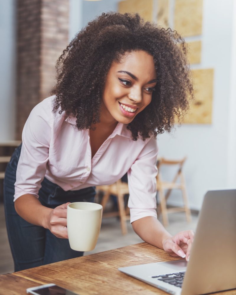 Pearl Lemon Accountants Office girl holding a cup in her hand while doing bookkeeping