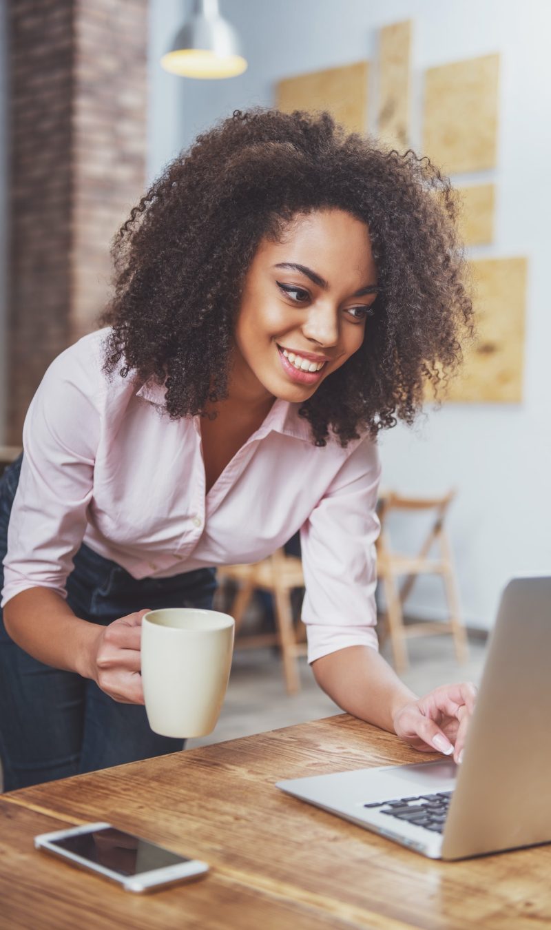Pearl Lemon Accountants Office girl holding a cup in her hand while doing bookkeeping