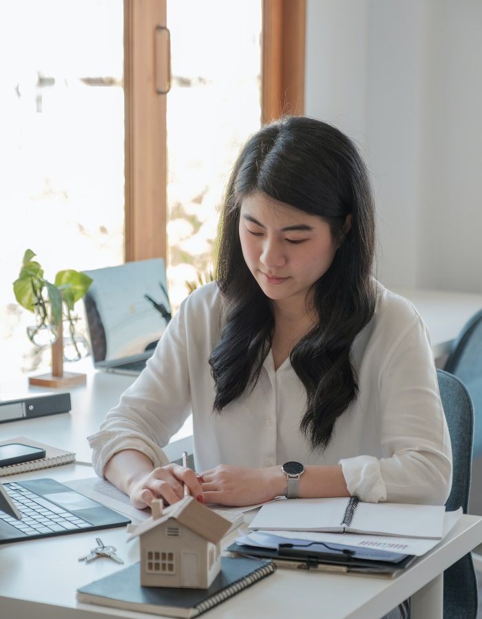 Office girl wearing a white shirt doing her job of bookkeeping and accounting
