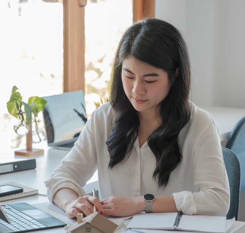 Office girl wearing a white shirt doing her job of bookkeeping and accounting