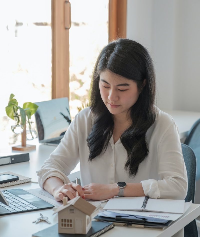 Office girl wearing a white shirt doing her job of bookkeeping and accounting