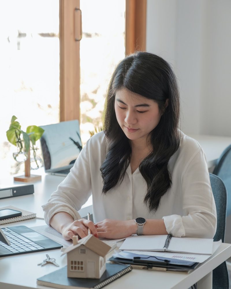 Office girl wearing a white shirt doing her job of bookkeeping and accounting