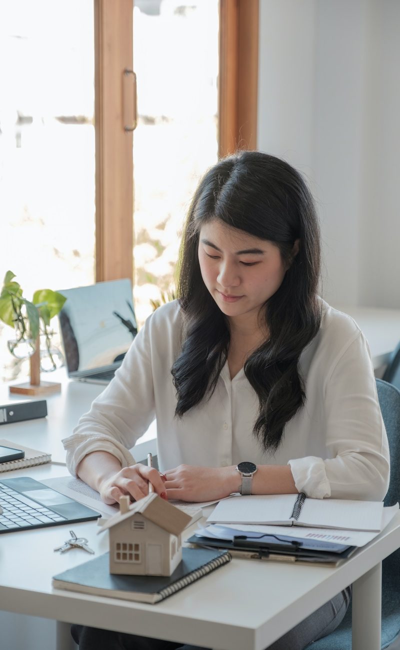 Office girl wearing a white shirt doing her job of bookkeeping and accounting
