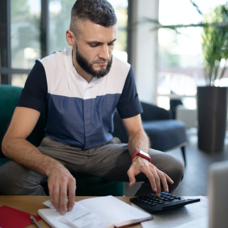 Businessman feeling involved in calculations and accounting