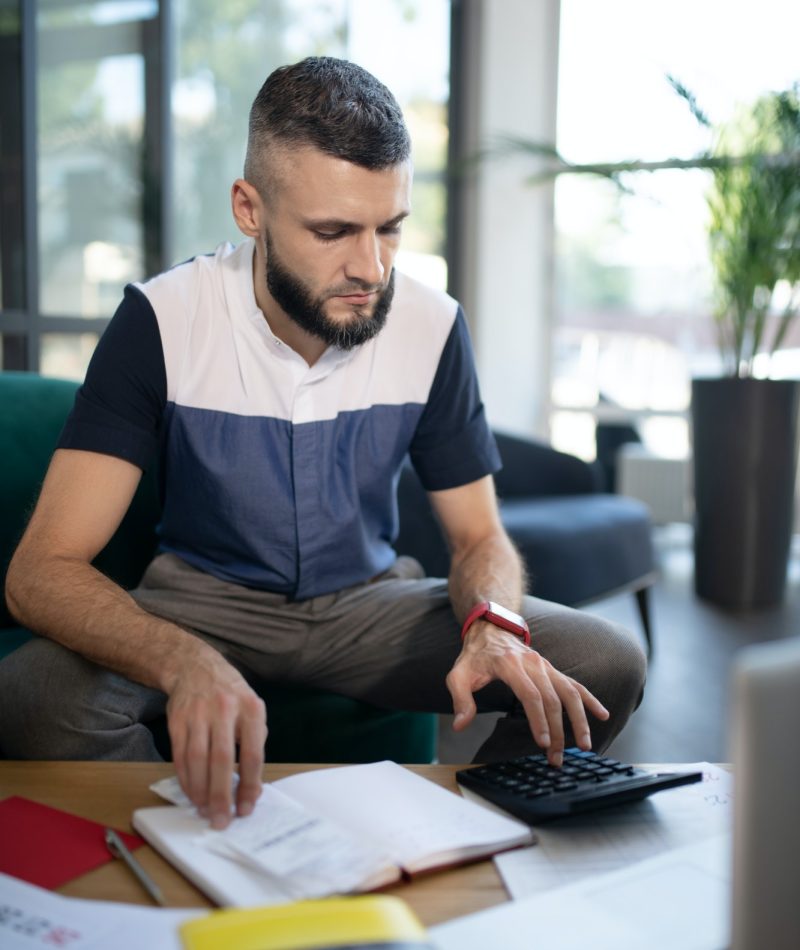 Businessman feeling involved in calculations and accounting