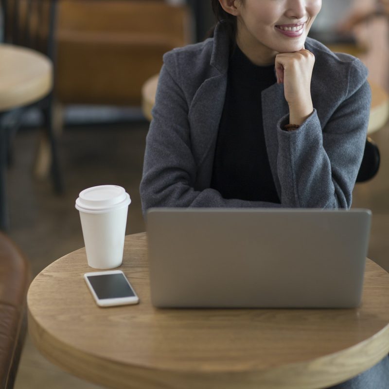 Businesswoman using laptop at the airport for bookkeeping