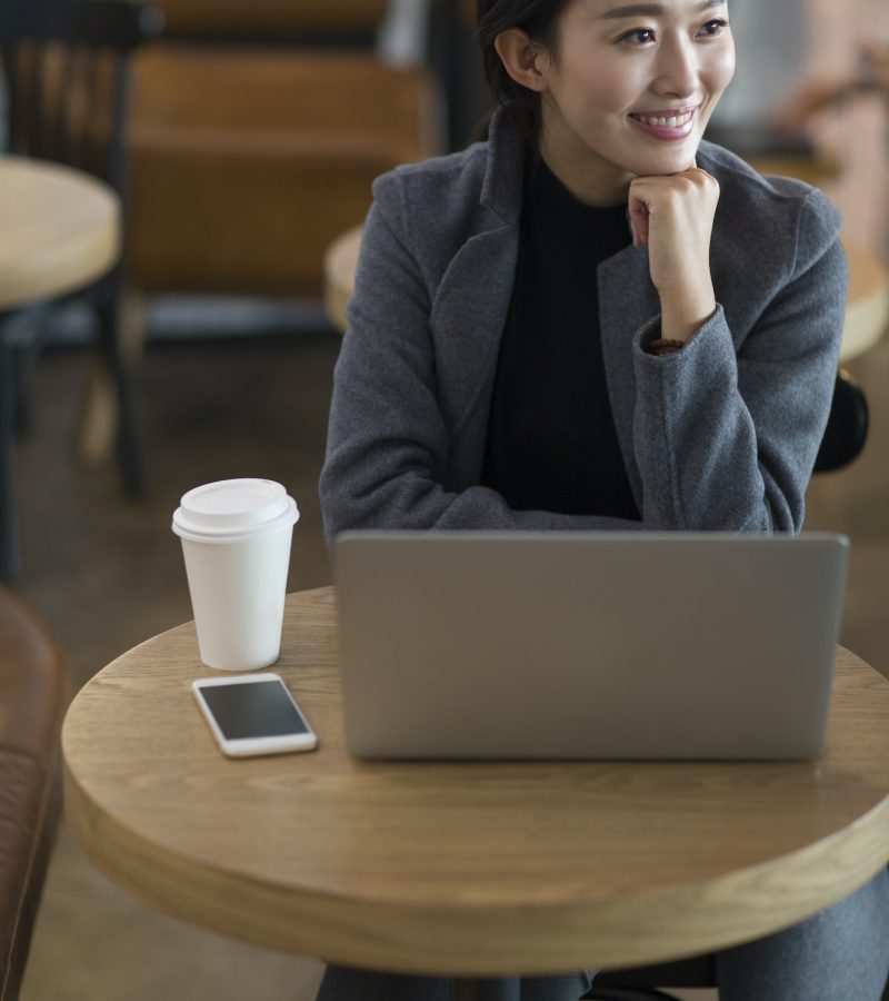 Businesswoman using laptop at the airport for bookkeeping