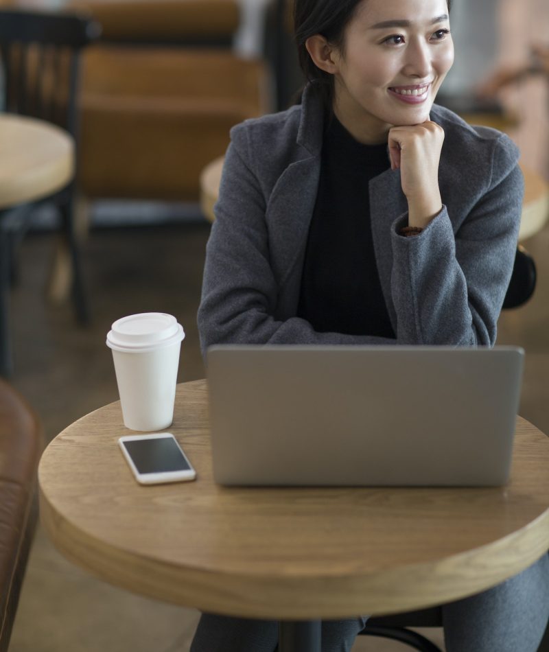 Businesswoman using laptop at the airport for bookkeeping