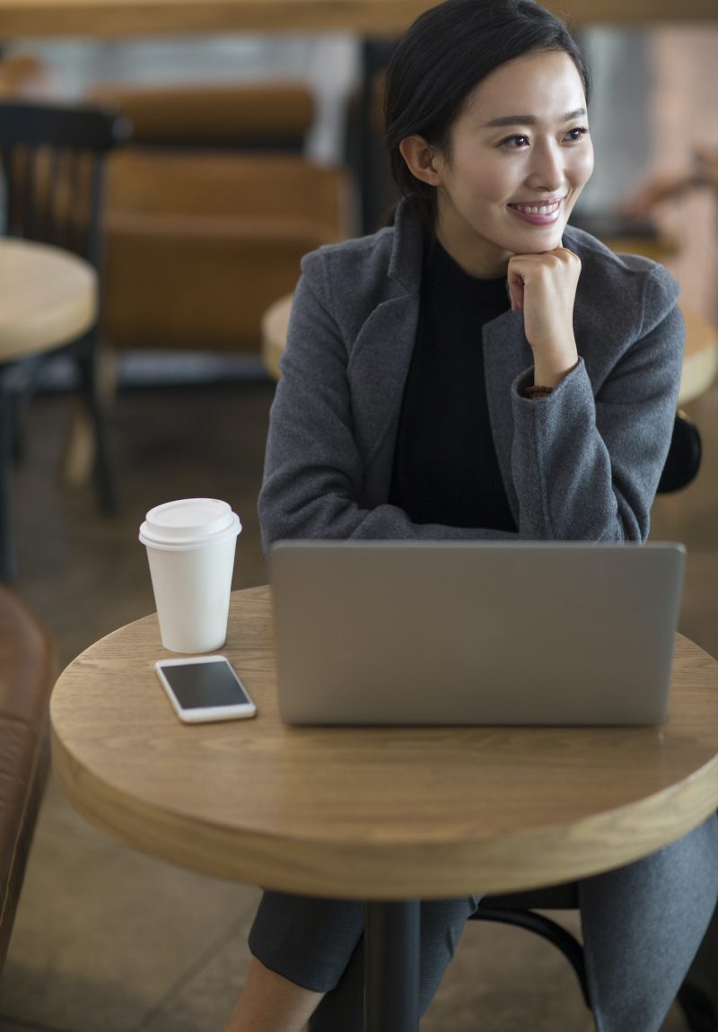 Businesswoman using laptop at the airport for bookkeeping