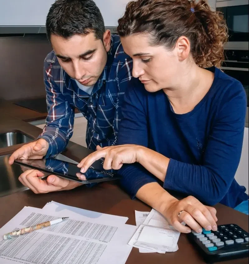 couple reviewing accounts with tablet