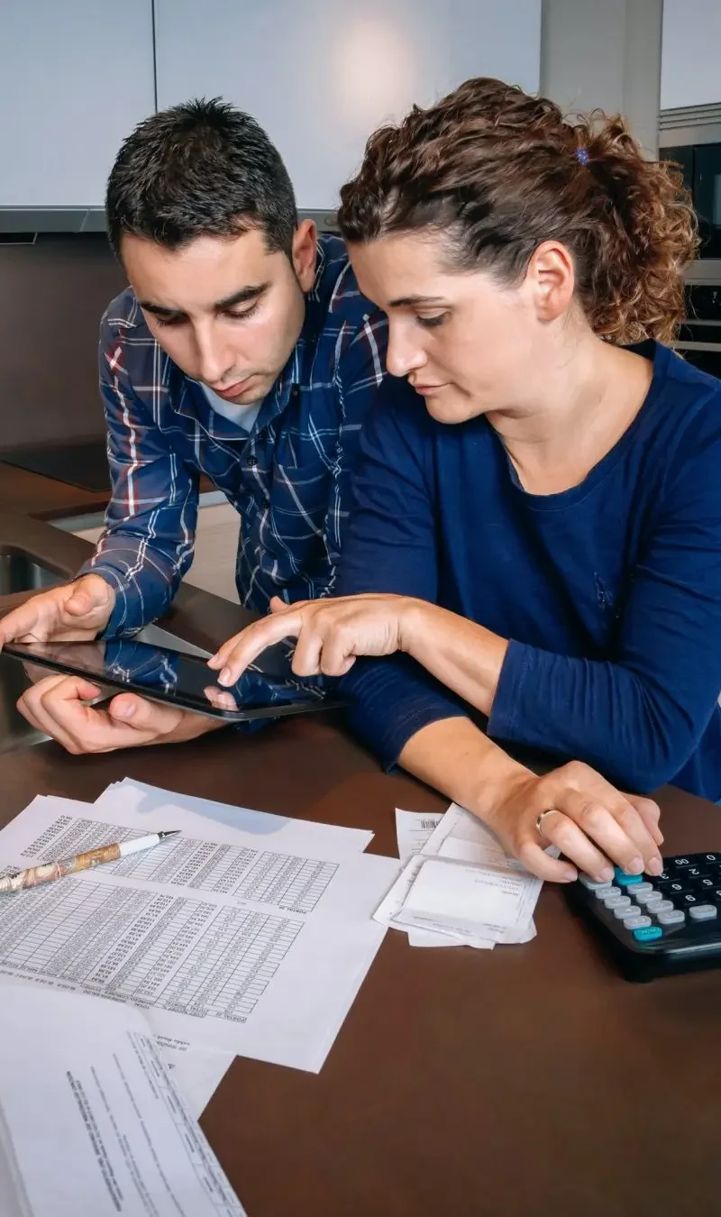 Personal Tax Services and Planning for Architects | Pearl Lemon Accountants Couple reviewing tax documents on a tablet