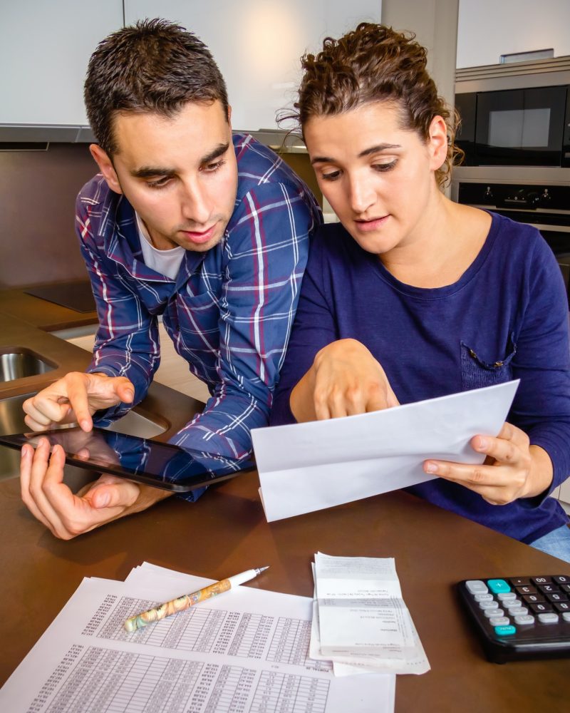 Couple reviewing their accounts with a digital tablet