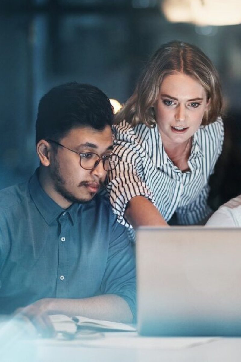 Girl showing accounting platforms to two office boys on a computer screen