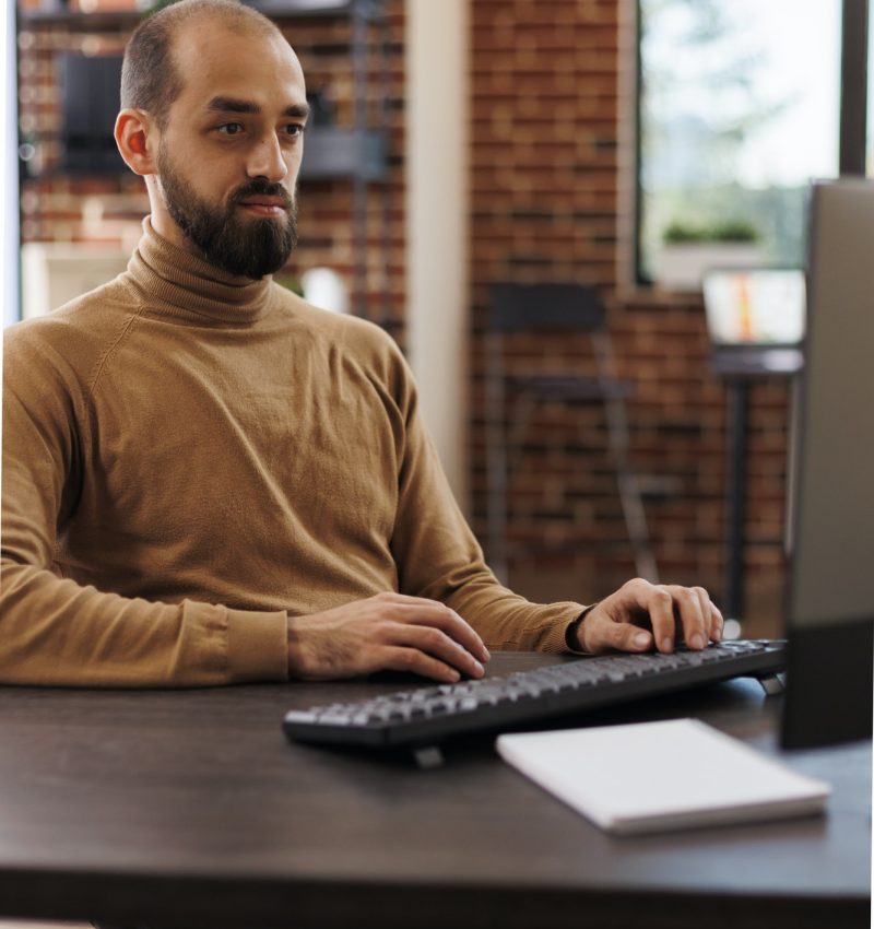 Bookkeeper or accountant sitting on a chair with a keyboard on the table