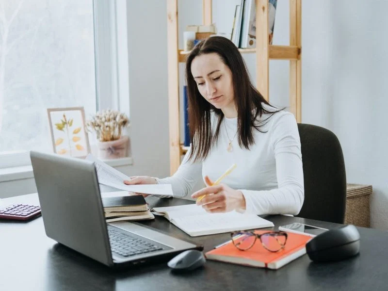 Female forensic accountant reviewing financial documents