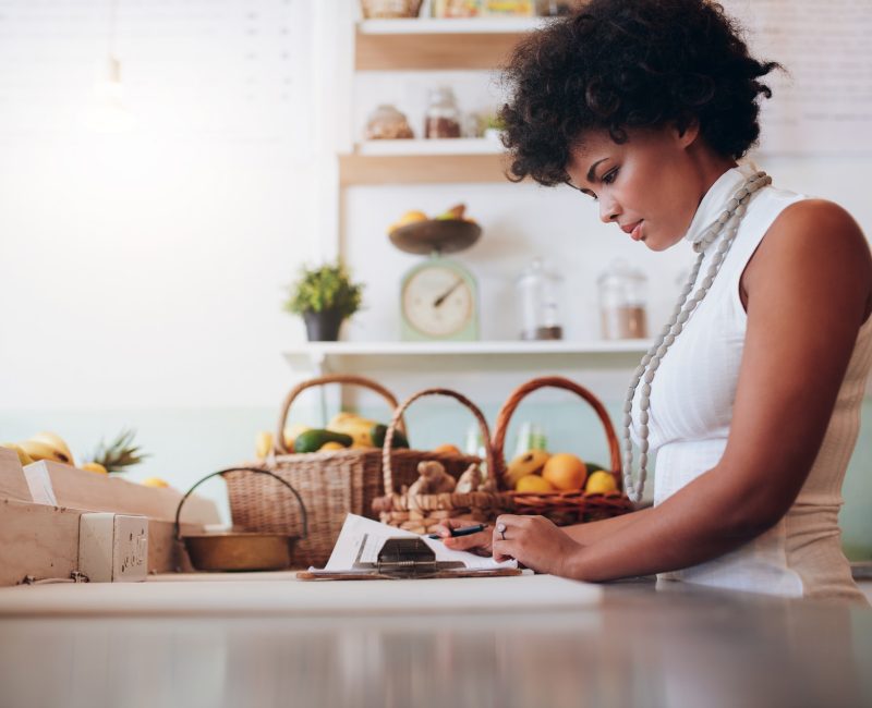 Female juice bar owner doing account
