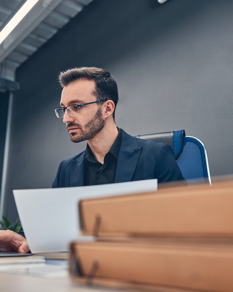 Financial accountant working on the laptop at the office desk Accountants For Forex Traders
