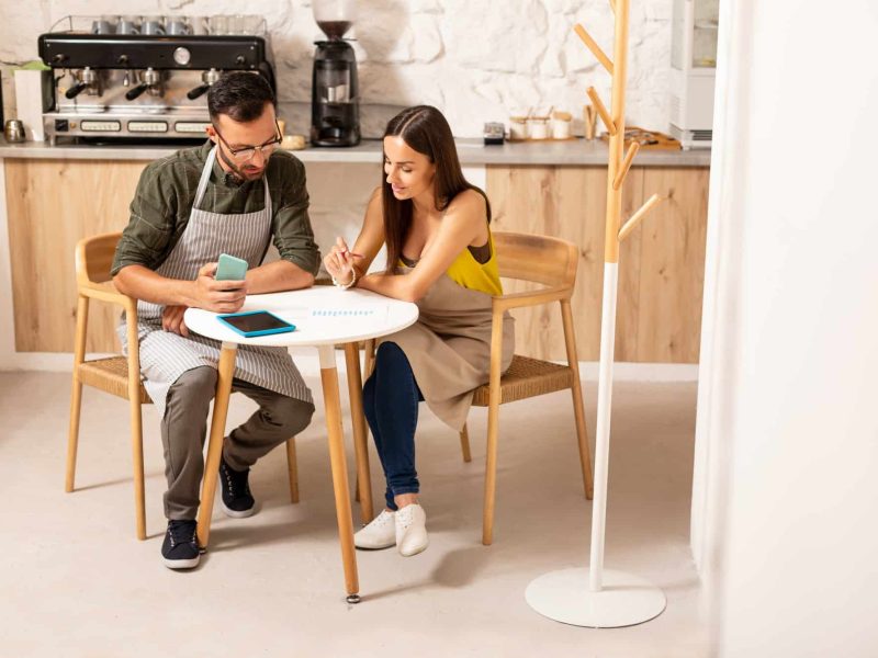 Husband helping wife with accounting after opening cafeteria Husband helping wife with accounting after opening cafeteria