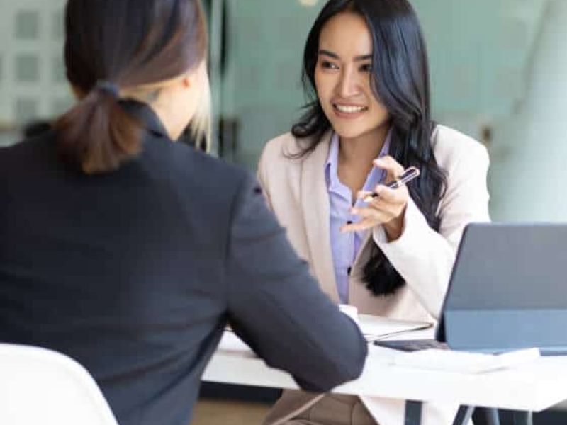 Businesswoman discussing with colleagues in the office, job interview.