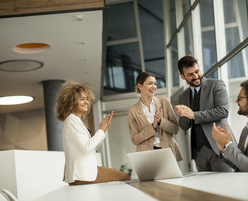 Four bookkeepers for real estate agents clapping