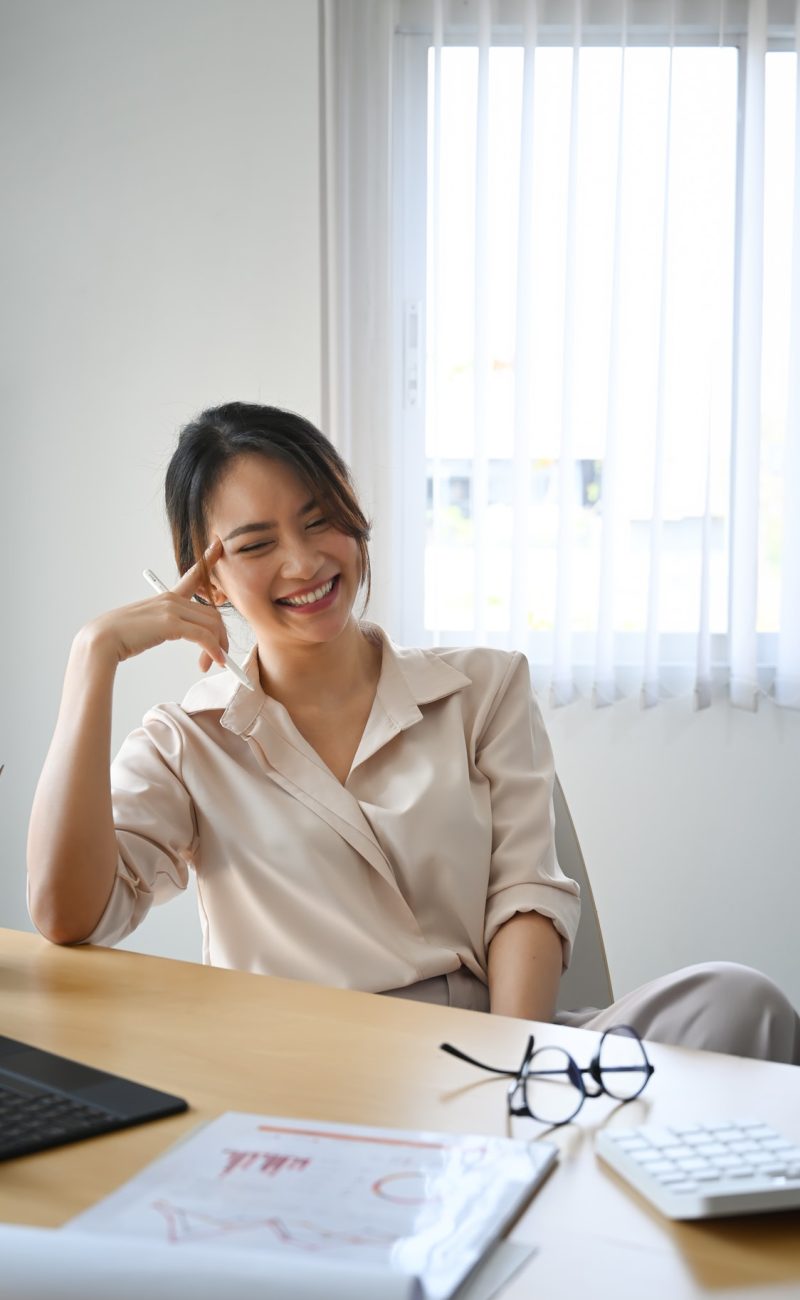 A happy woman smiling after finishing accounting for the forex trading