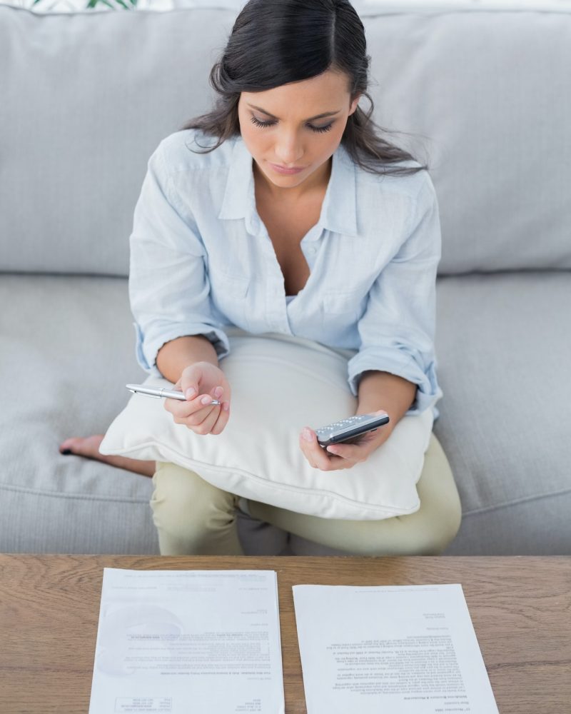 Pretty woman doing her accounts in her living room, Accountants for Entertainment Industry, Accountants for crypto traders, Accountants for Investment Property