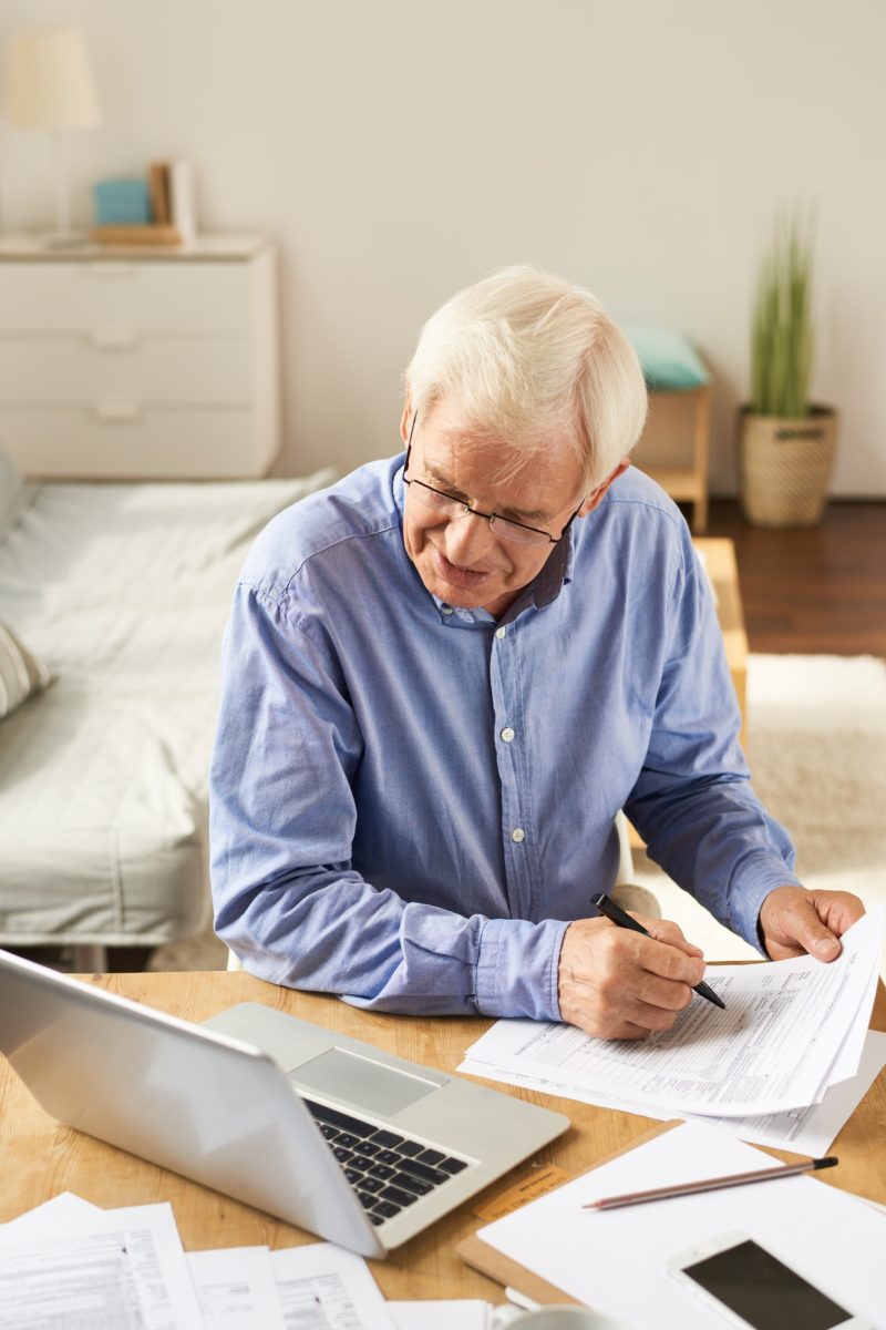 Senior Man Filling Application at Home, Accountants for Charities