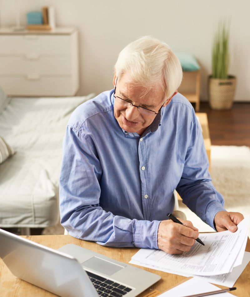 Senior Man Filling Application at Home