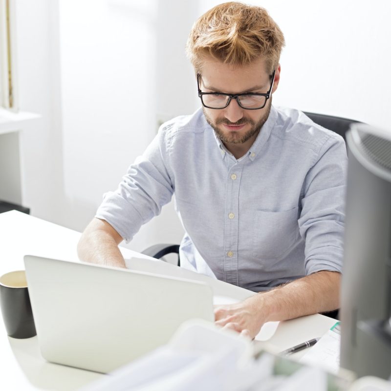 Accountant and bookkeeper using a laptop in the office